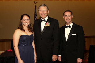 Men in tuxedos, woman in dress